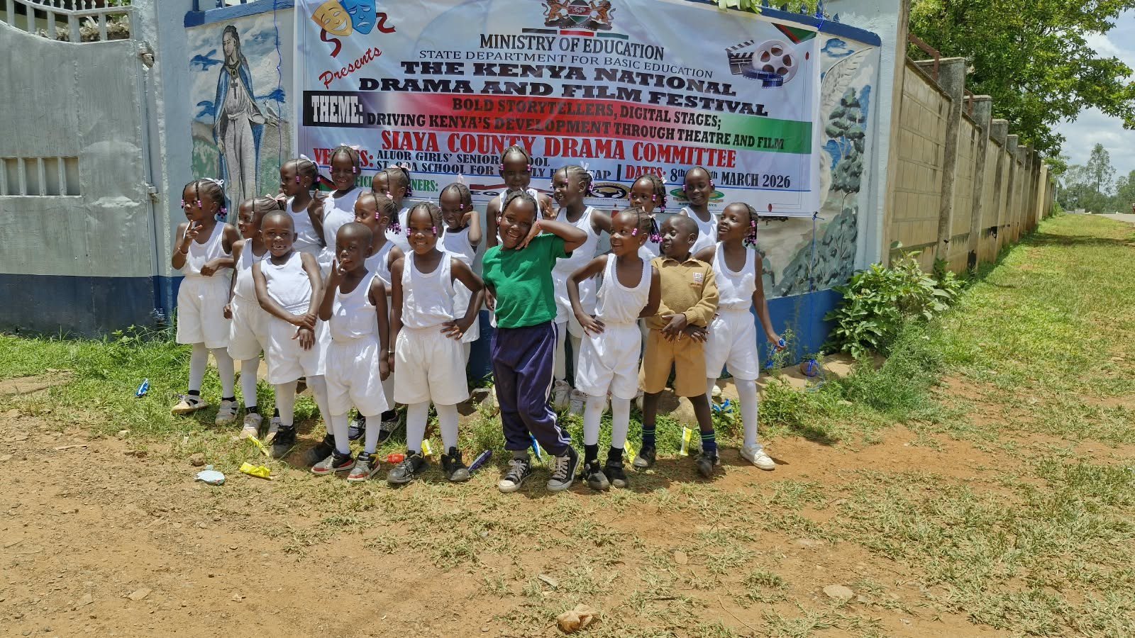 Learners at the drama festival banner